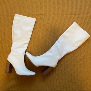 White pleather knee high boots with brown sole and side zipper. Size US 8.